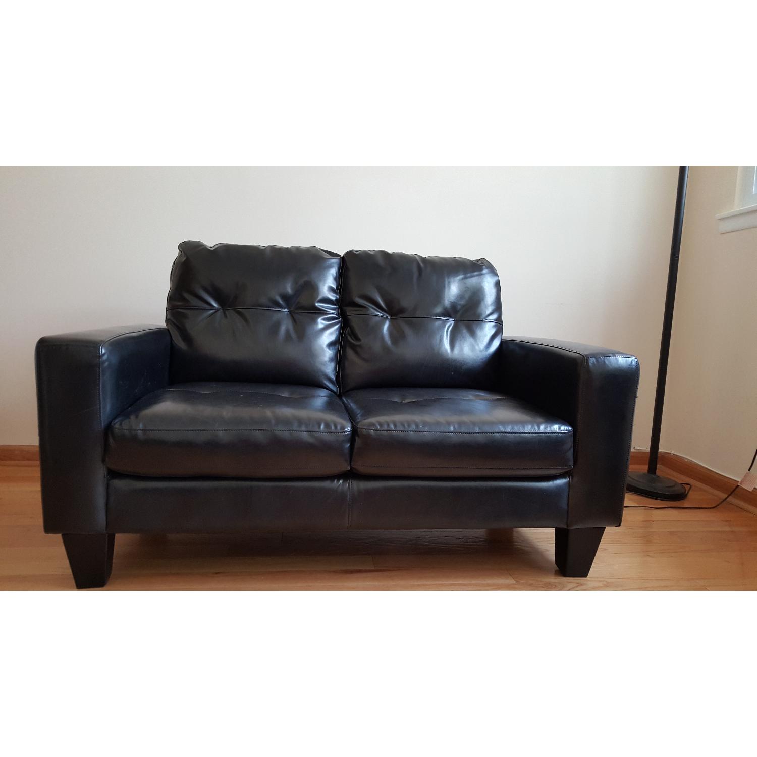 Jennifer Convertible Black Faux Leather Loveseat - image-1