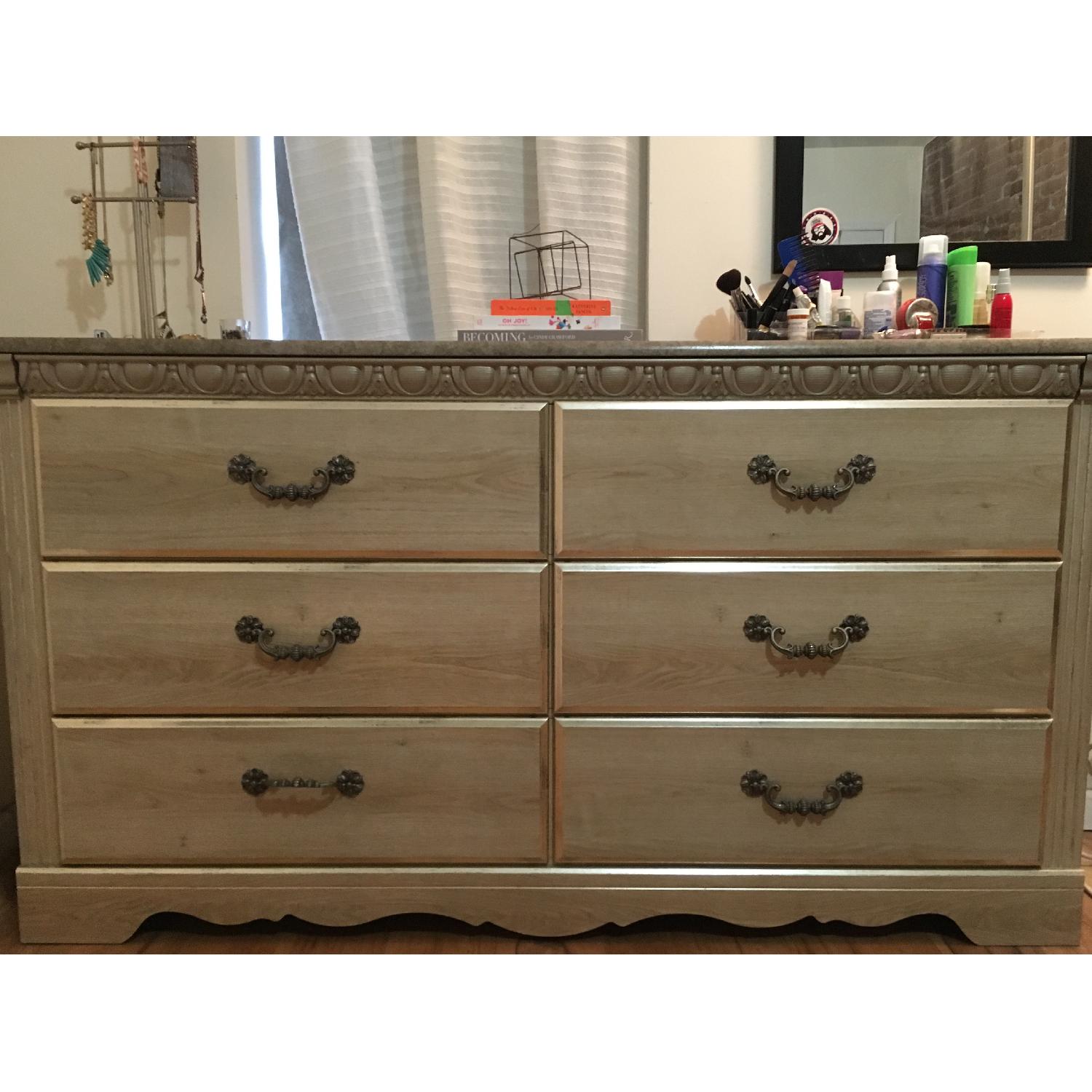 Ashley's 6 Drawer Marble Top Dresser AptDeco