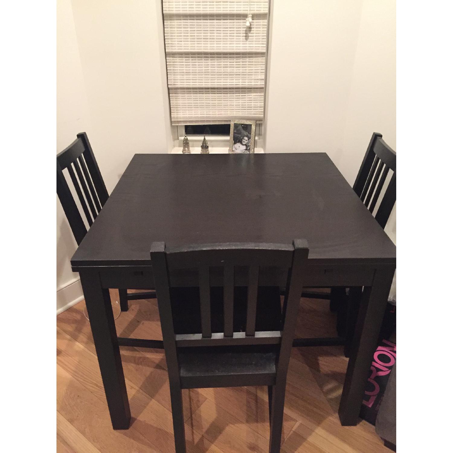 Ikea Bjursta Extendable Dining Table w/ 4 Brown Stefan Chairs - AptDeco