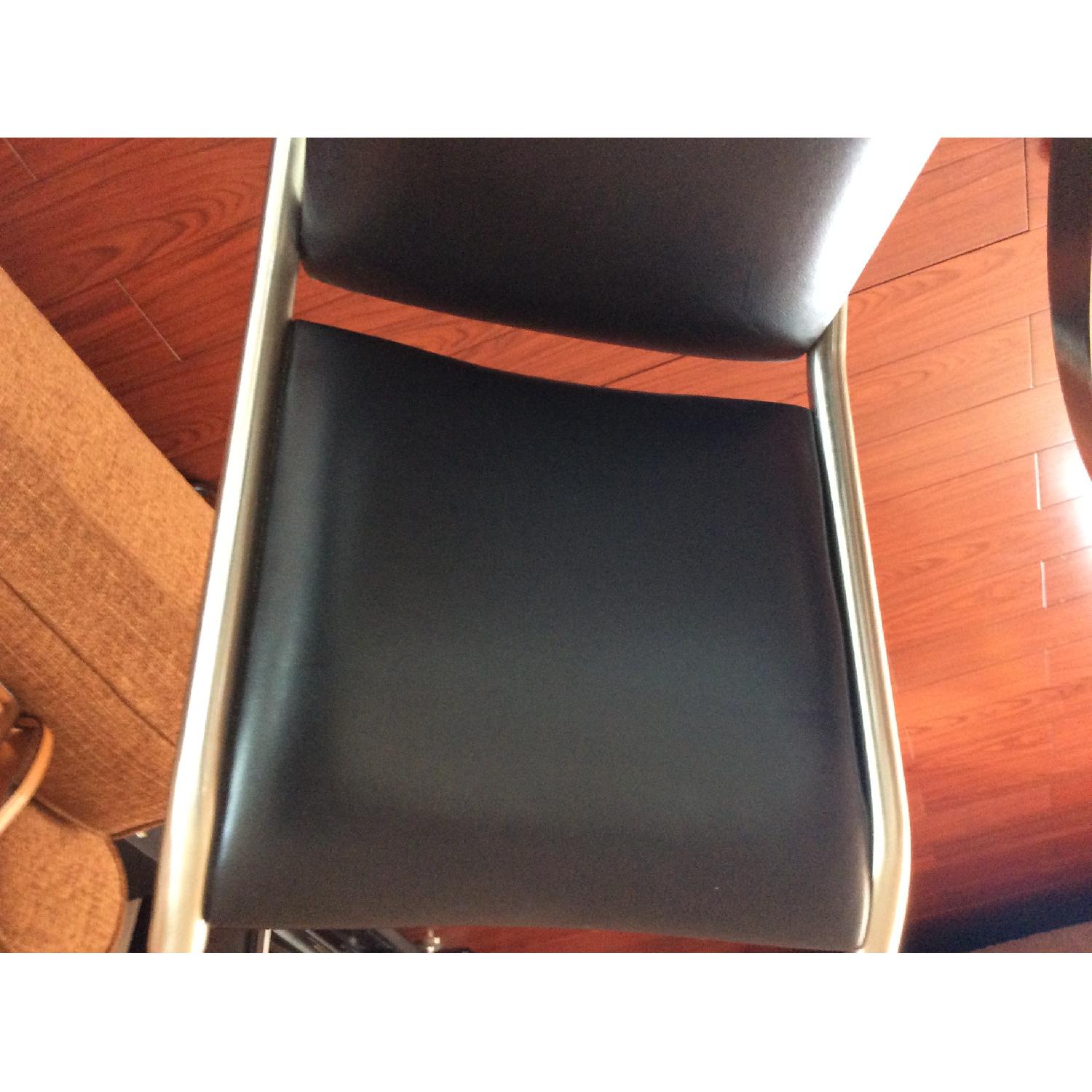 Bloomingdale's Sphere Dining Table w/ 4 Black Leather Chairs AptDeco