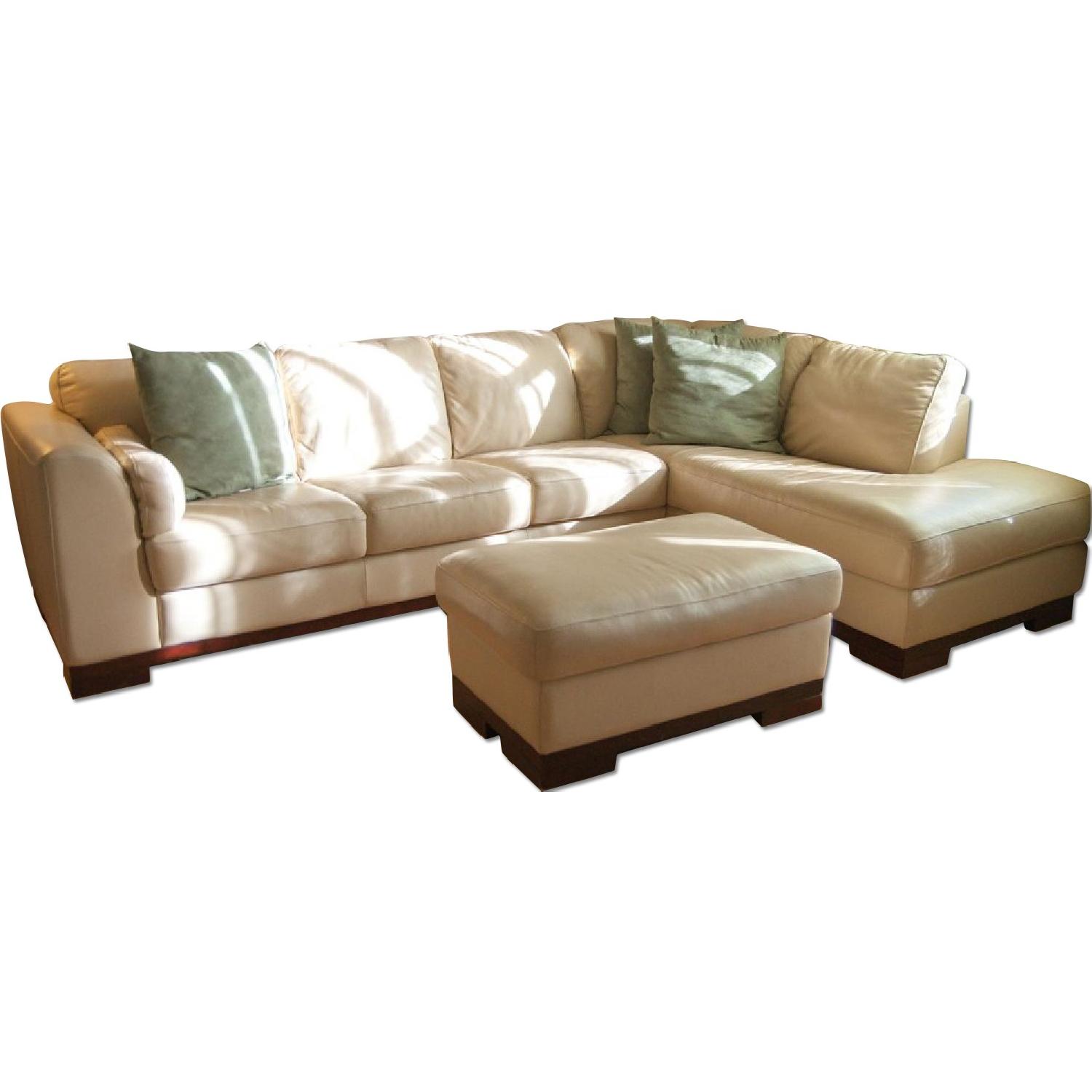 Jordan's Leather Sectional Couch w/ Storage Ottoman - image-0