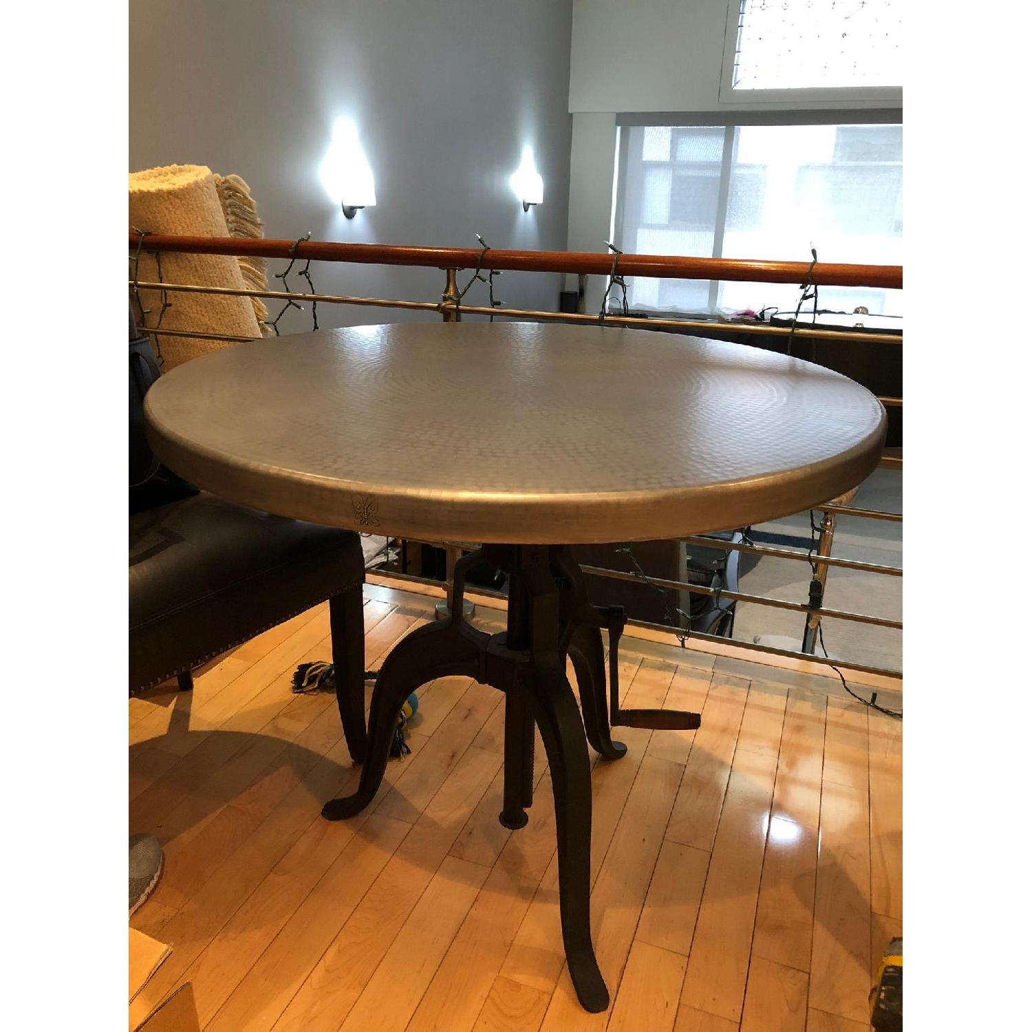 Arhaus Hammered Zinc Alloy Top Dining Table w/ Edison Base AptDeco