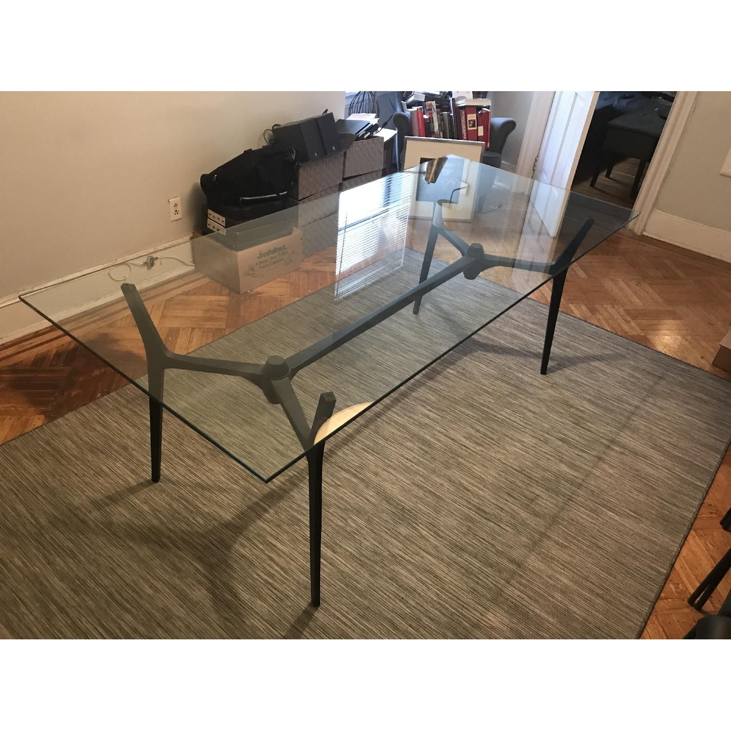 CB2 Glass Dining Table w/ Black Metal Base AptDeco