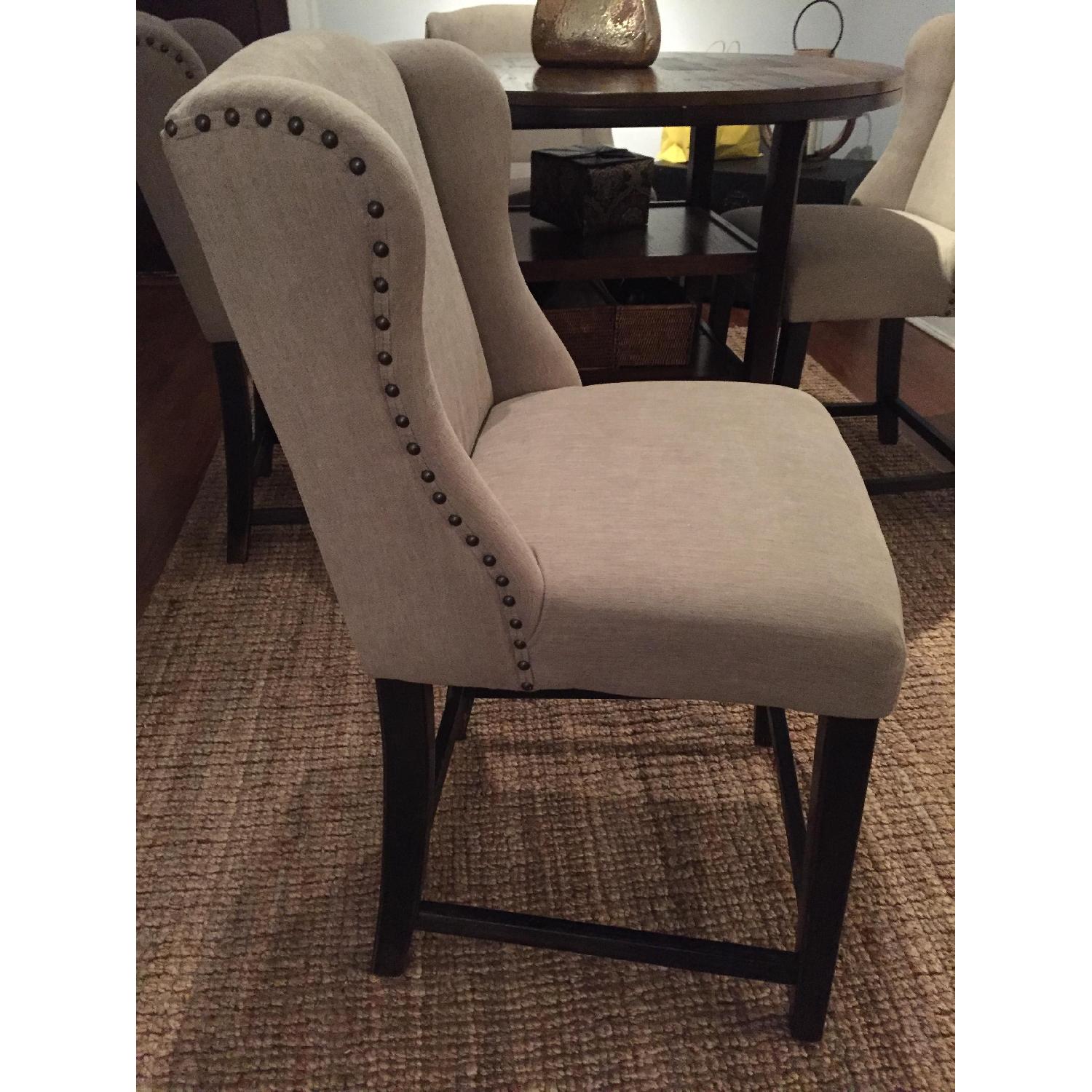 Ashley's Tall Dining Table w/ 4 Upholstered Chairs AptDeco