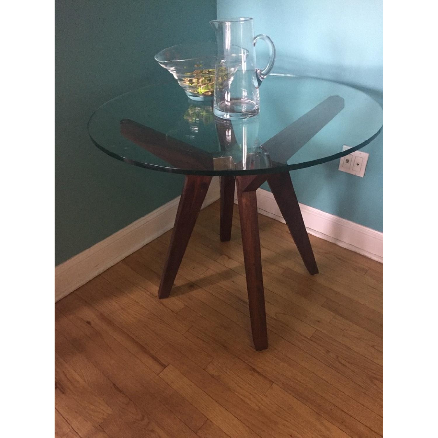 Crate & Barrel Strut Modern Round Glass Dining Table AptDeco