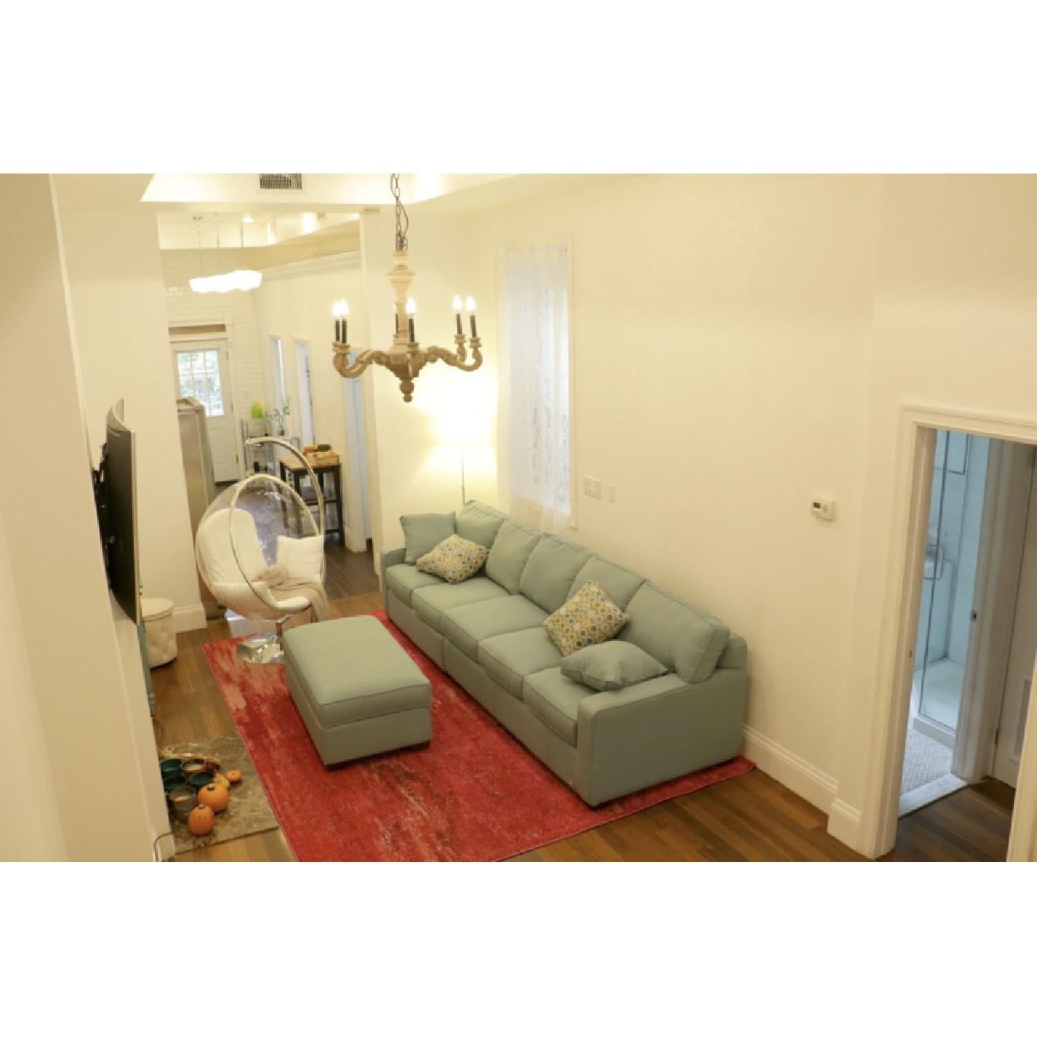 Jennifer Convertibles Aqua Green Sectional Sofa & Ottoman - image-1