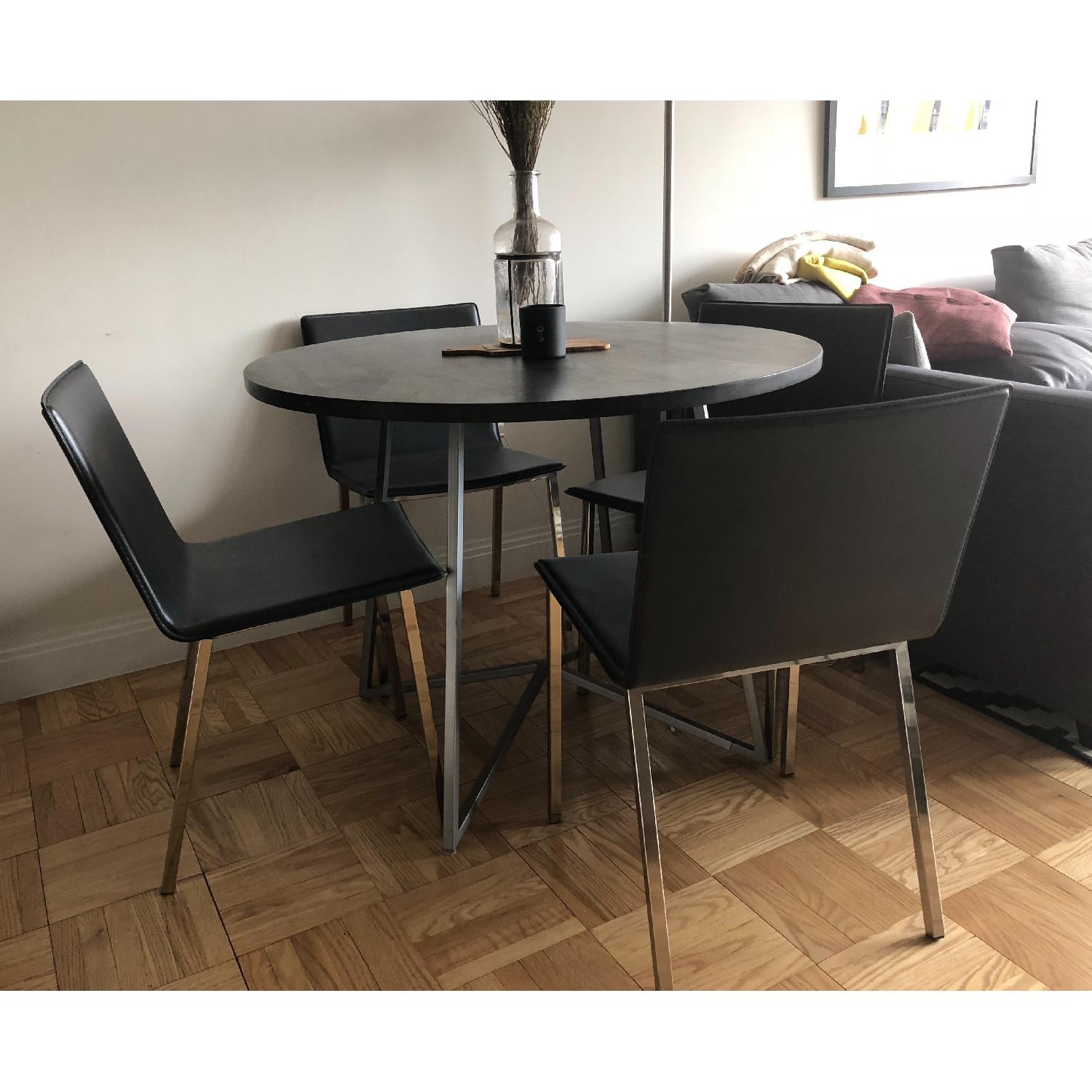 CB2 Peak Round Dining Table w/ 4 Phoenix Carbon Chairs - AptDeco
