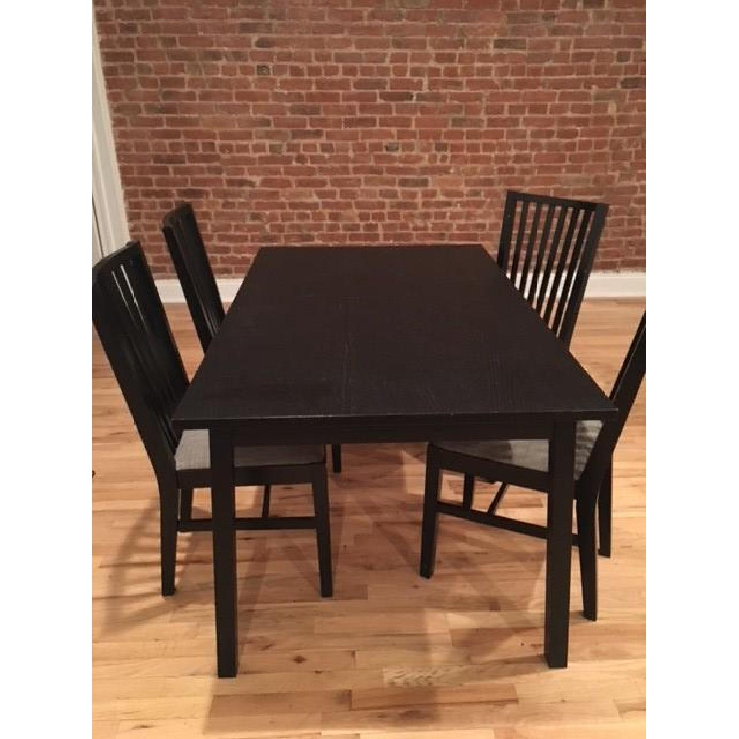 Ikea Black Bjursta Table w/ 4 Cushioned Chairs - AptDeco