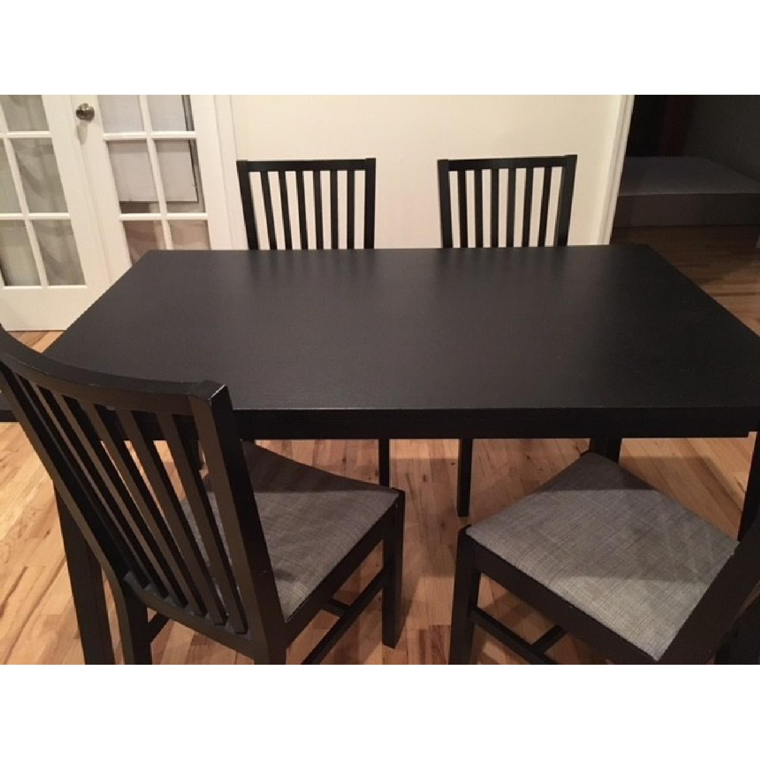 Ikea Black Bjursta Table w/ 4 Cushioned Chairs - AptDeco