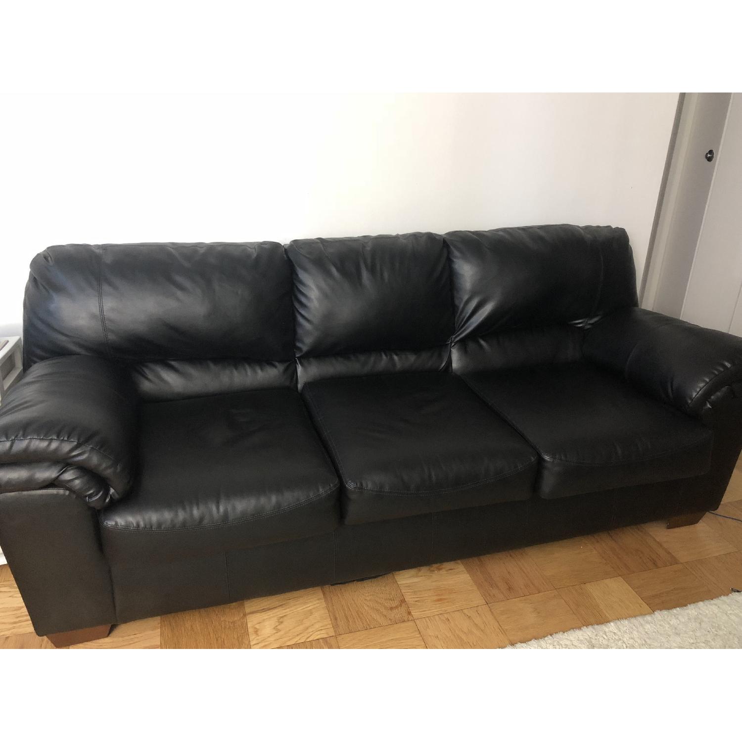 Ashley Black Faux Leather Sofa - image-1