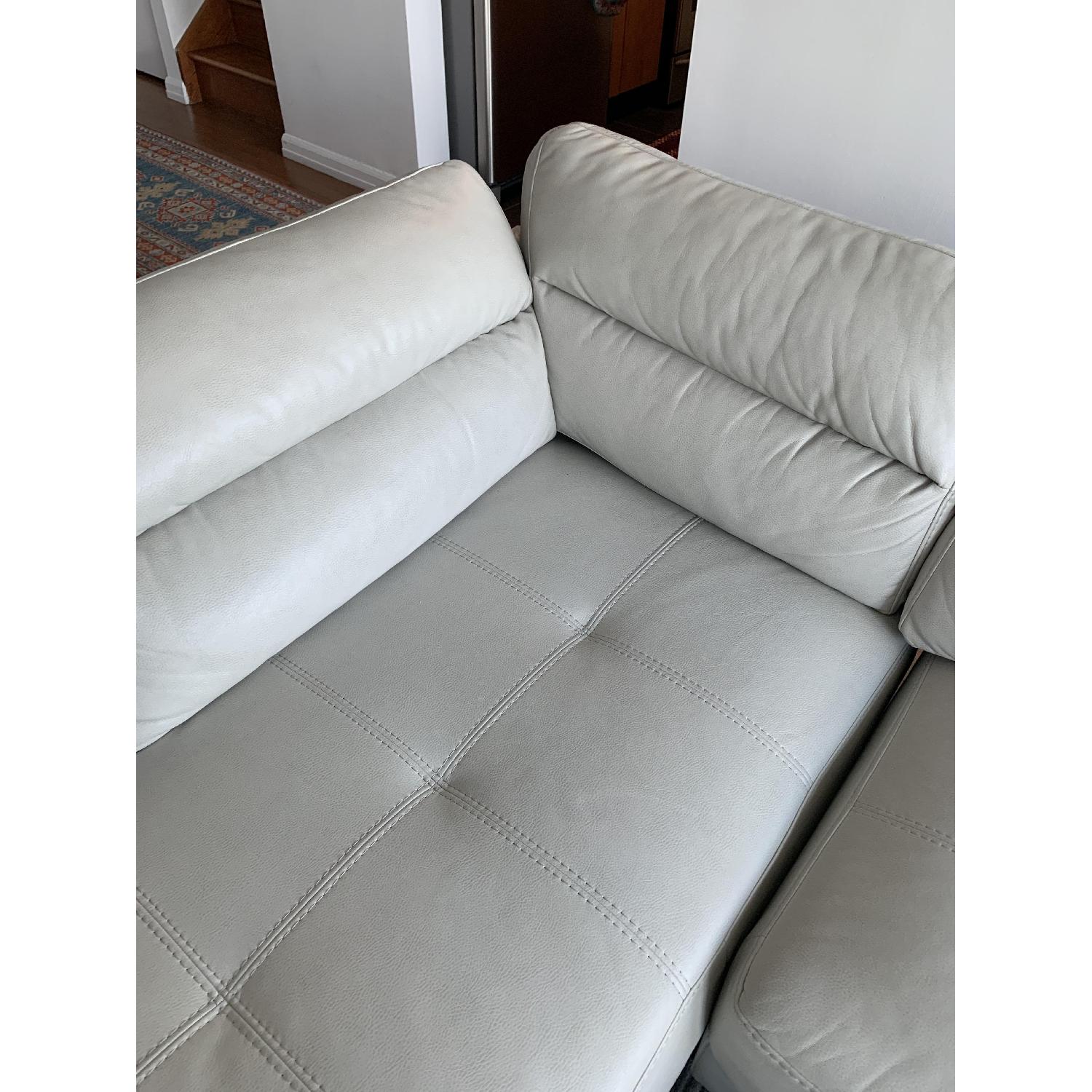 Rooms To Go Off White Faux Leather Sectional Sofa & Ottoman - image-3