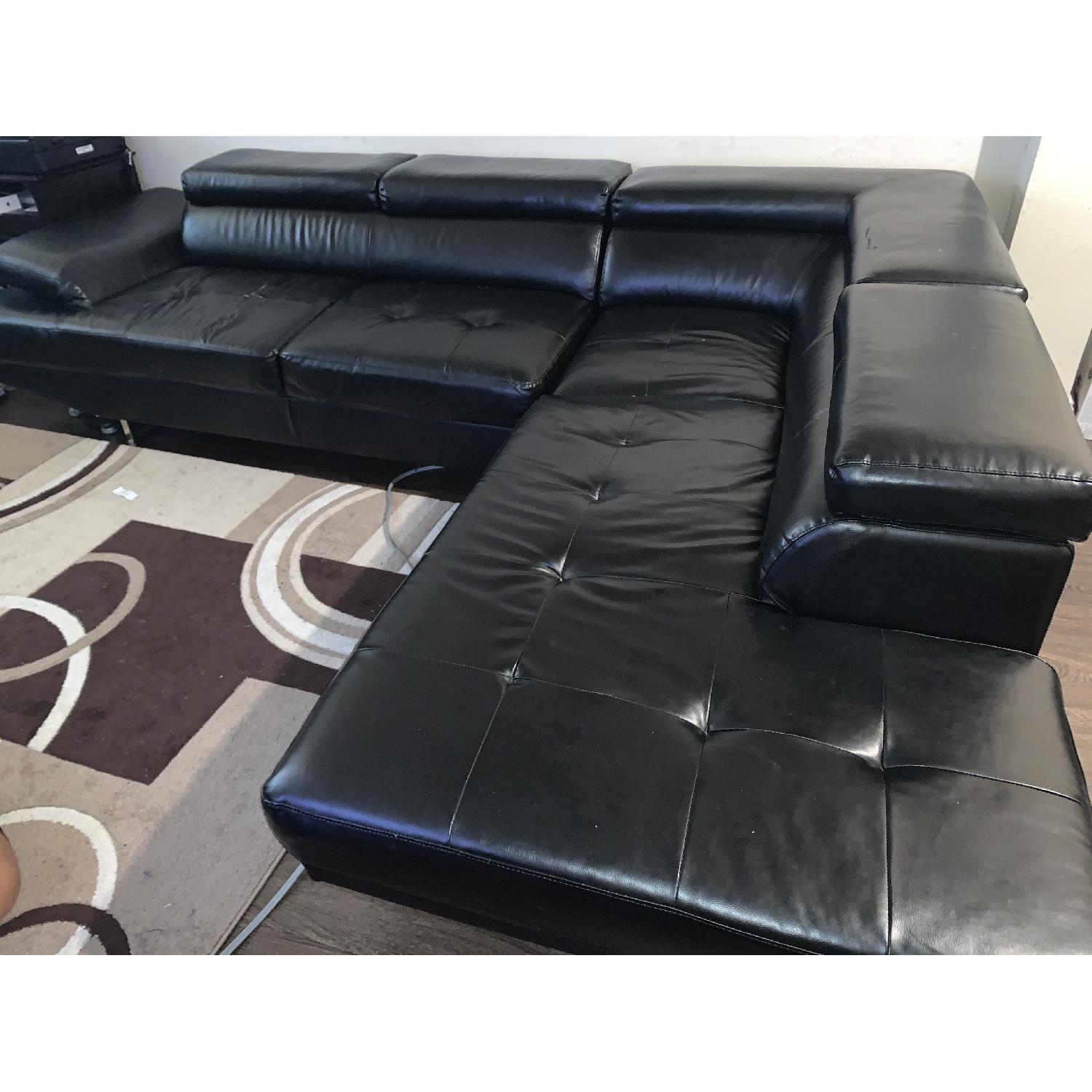 Bob's Black Leather Sectional Sofa AptDeco
