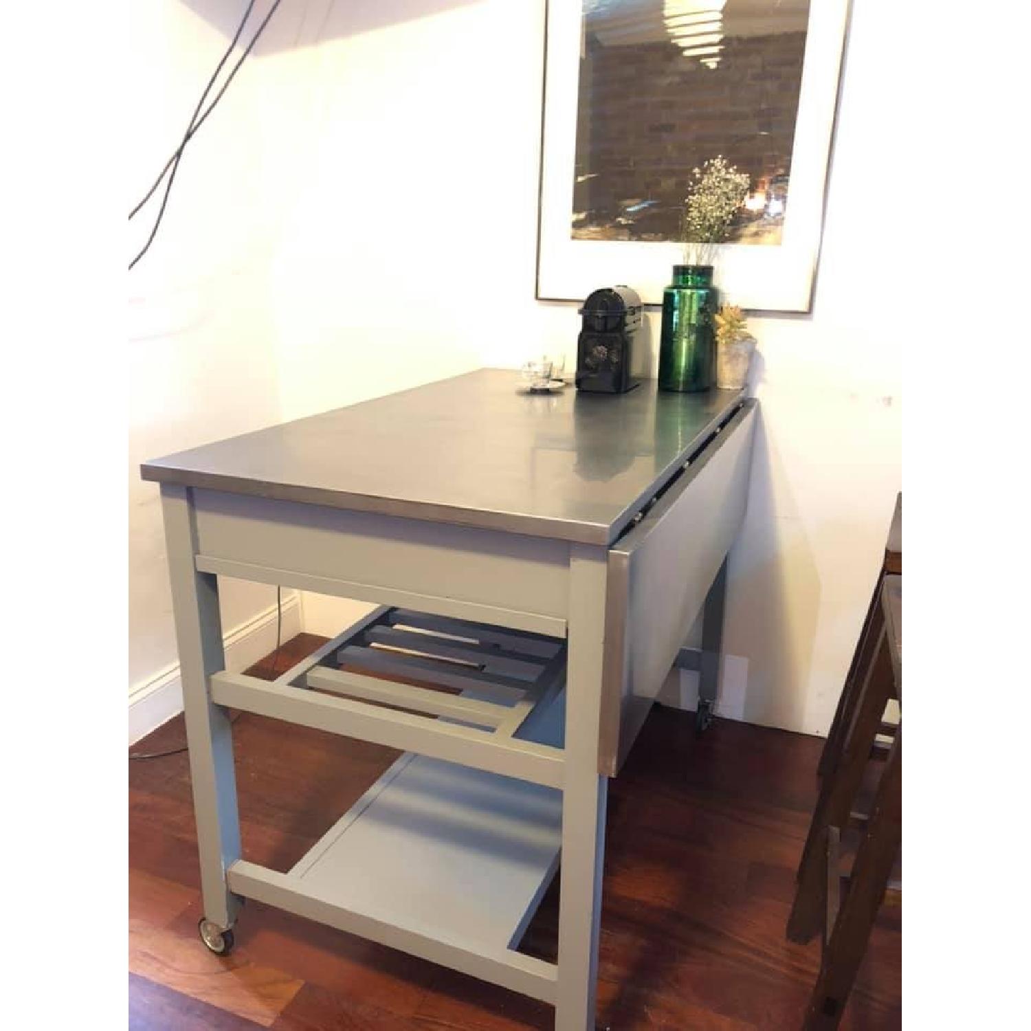 Crate & Barrel Kitchen Island w/ 2 Spin Bar Stools AptDeco