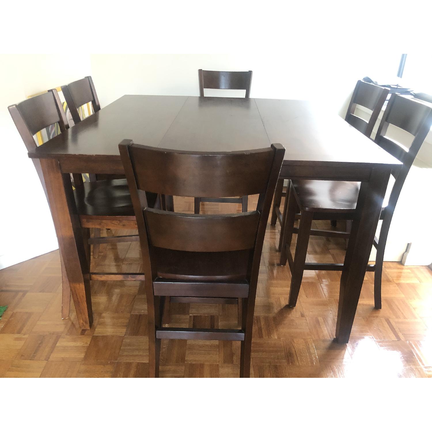 Dark brown dining table w/ 6 chairs & an extension piece. - image-6