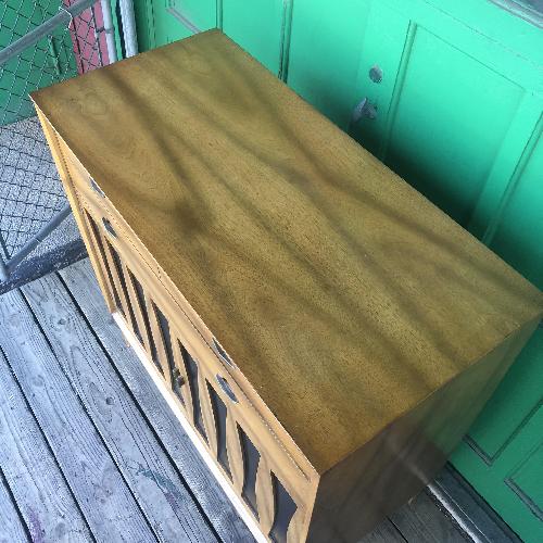 Used Mid century Highboy dresser with black vinyl accents for sale on AptDeco