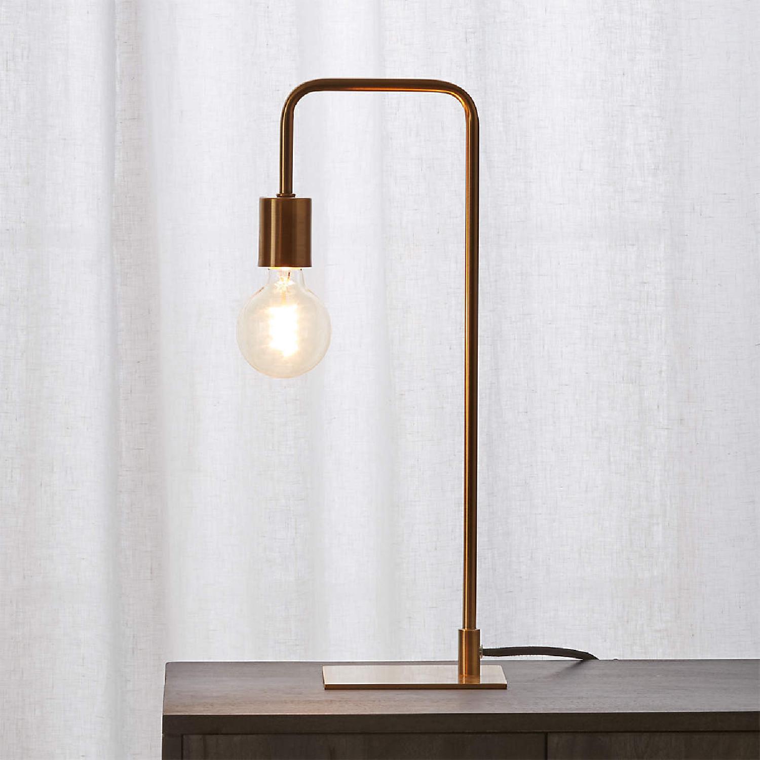 CB2 antique brass arc table lamp AptDeco
