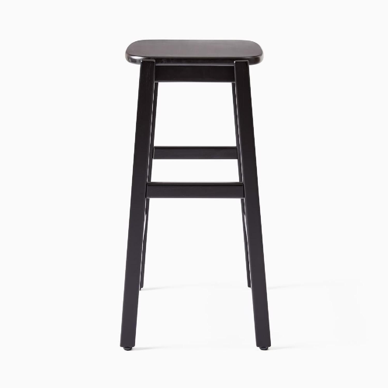 West Elm Lloyd Black Wood Stools AptDeco