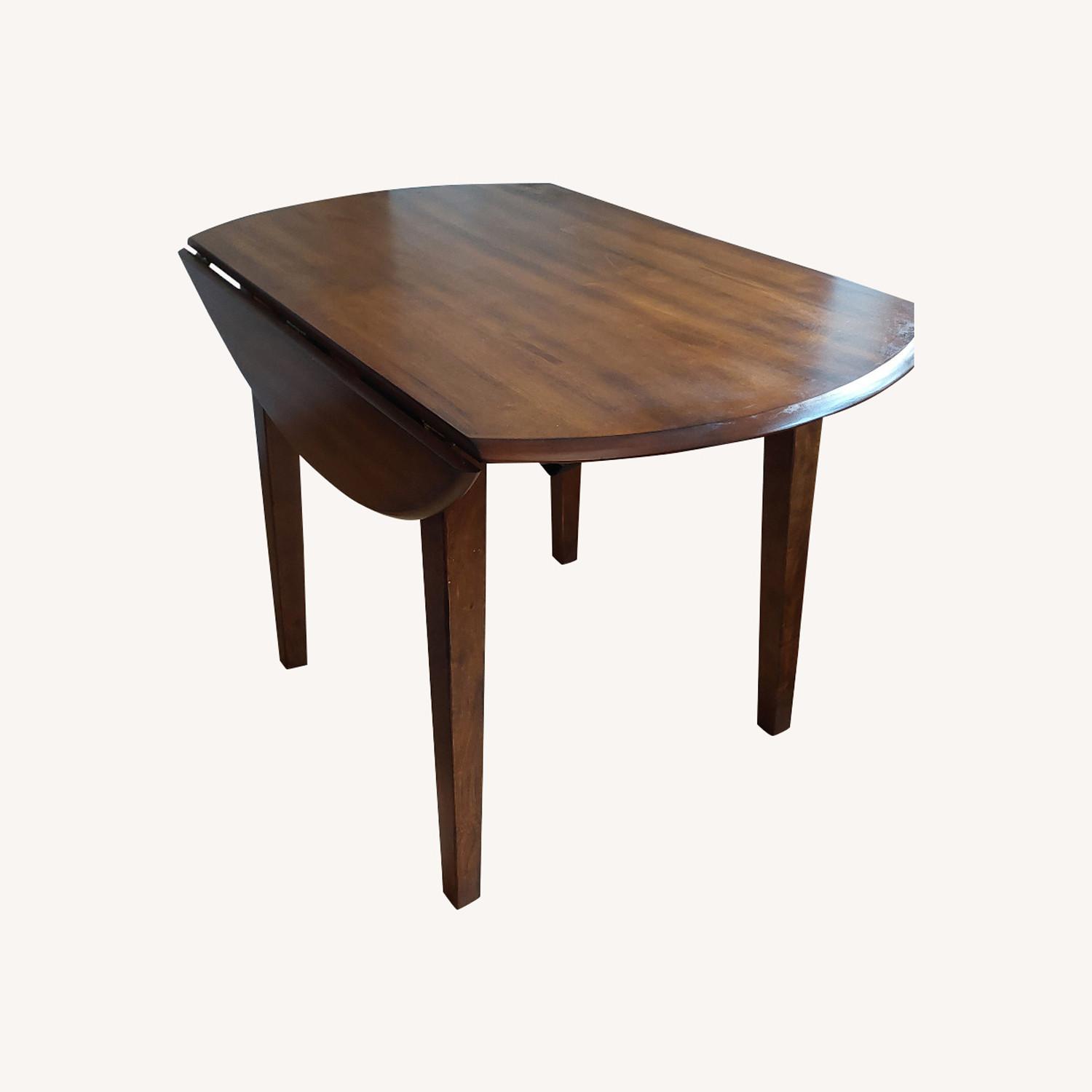 Ashley's Berringer Round Drop Leaf Dining Table AptDeco