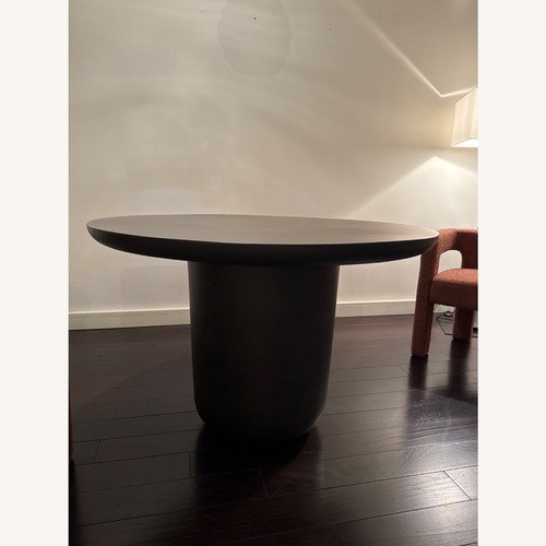 Used CB2 Lola 45" Round Black Concrete Dining Table for sale on AptDeco