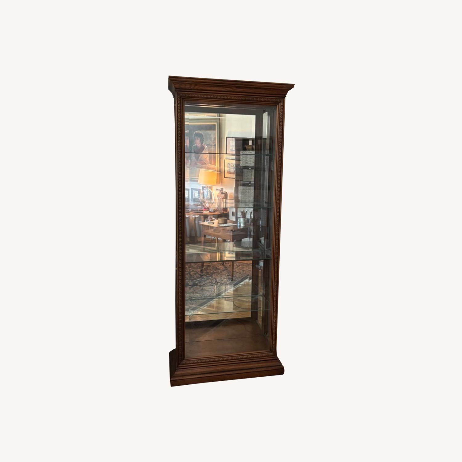 Howard Miller Wood and Glass Curio Cabinet - image-0