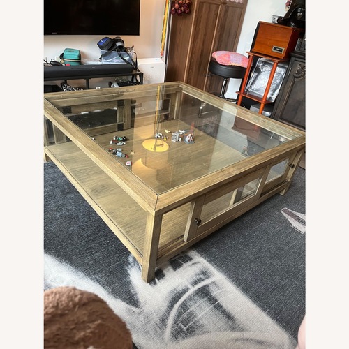 Used Riverbend Home Glass Display Coffee Table for sale on AptDeco