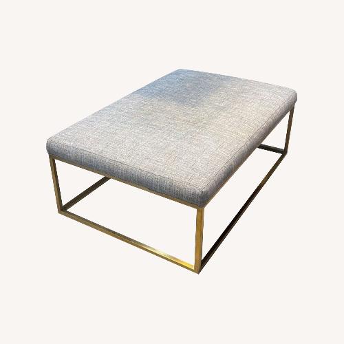 Used Contemporary Upholstered w Brass Legs Ottoman for sale on AptDeco