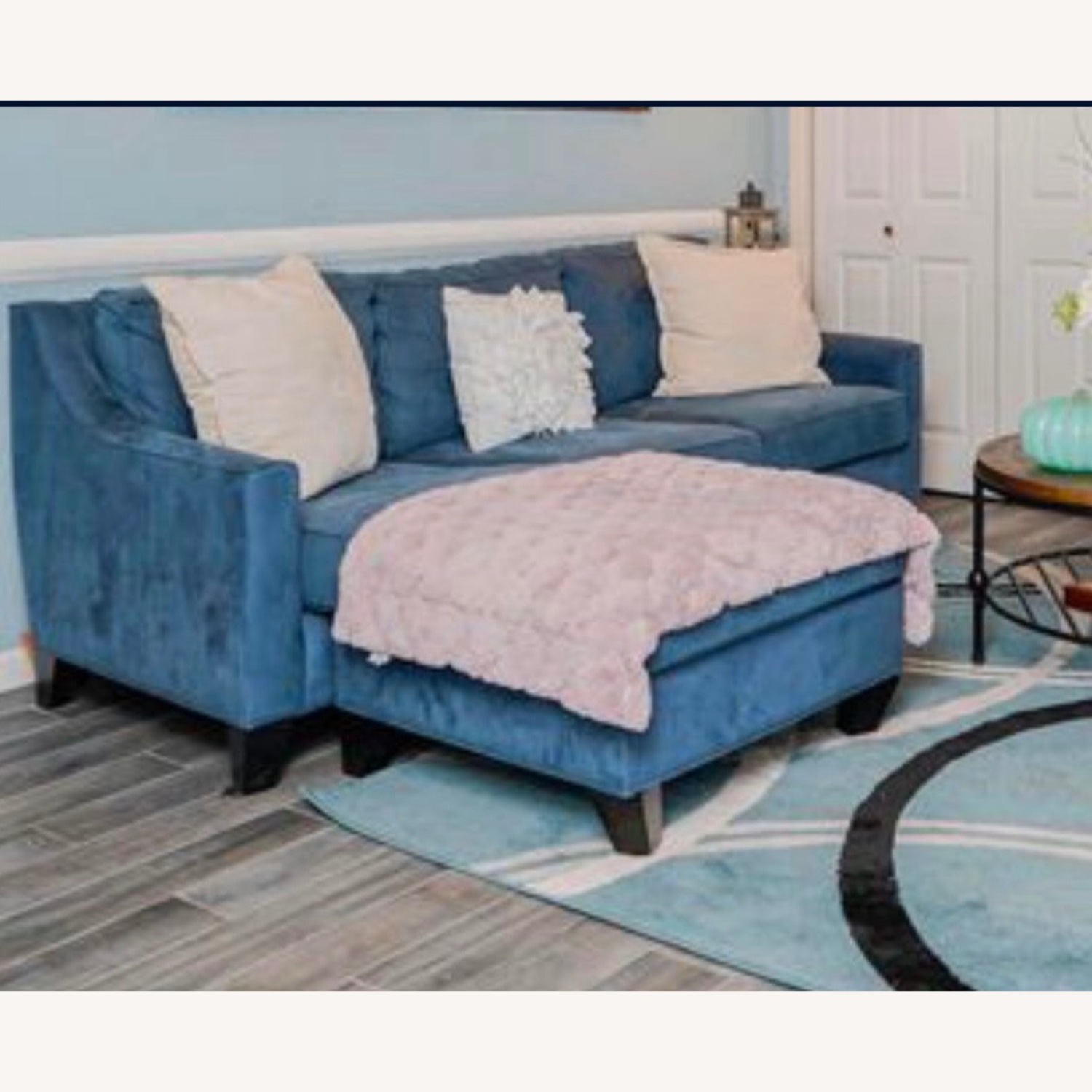Stylish Blue Sofa Behind Ottoman - image-1