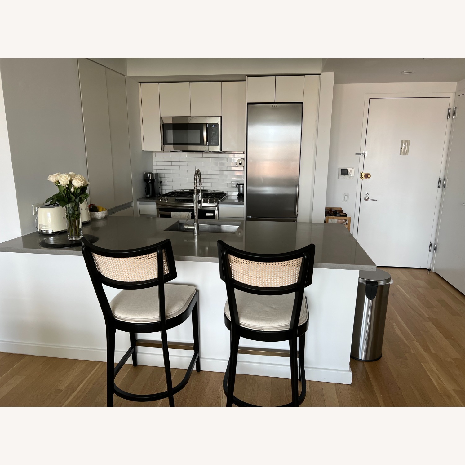 Crate & Barrel Libby Black and Natural Cane Stools - image-1