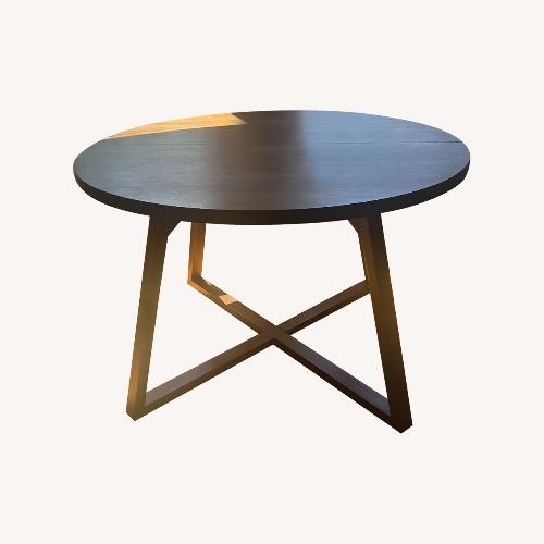 Used World Market Round Expandable Wood Dining Table for sale on AptDeco