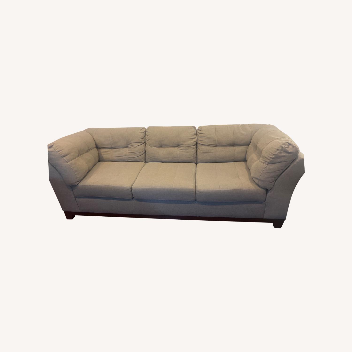 Medium grey two piece sectional with ottoman.   - image-0