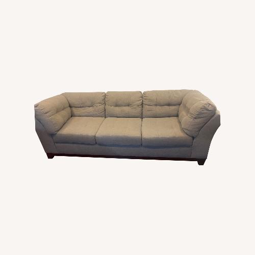 Used Medium grey two piece sectional with ottoman.   for sale on AptDeco