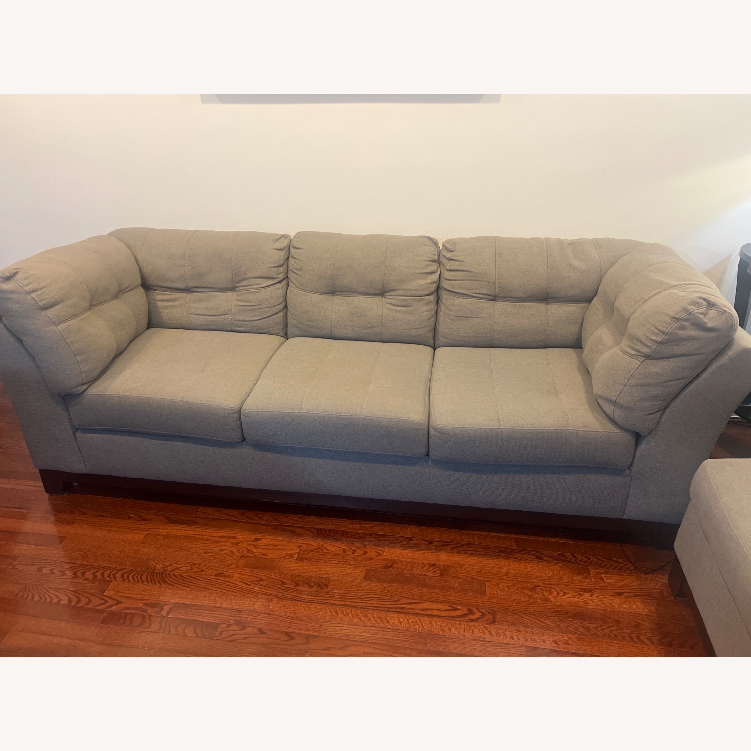 Medium grey two piece sectional with ottoman.   - image-1