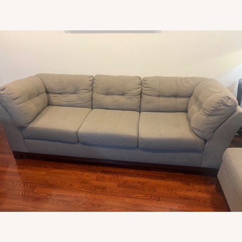 Used Medium grey two piece sectional with ottoman.   for sale on AptDeco