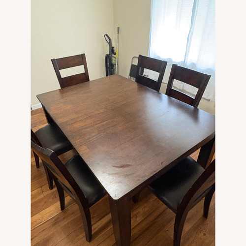 Used Solid Dining Table and Chairs Set for sale on AptDeco