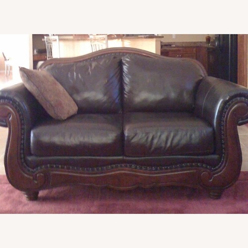 Used Dark Brown Leather Camel Back Loveseat for sale on AptDeco