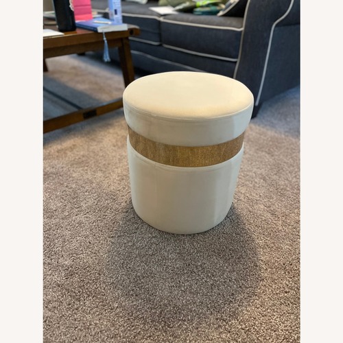 Used Cream Ottoman with Gold Band for sale on AptDeco