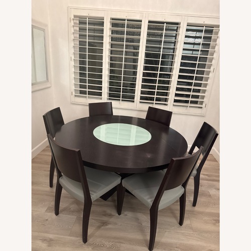Used Dark Brown Wood Round Dining Table with 6 Chairs for sale on AptDeco