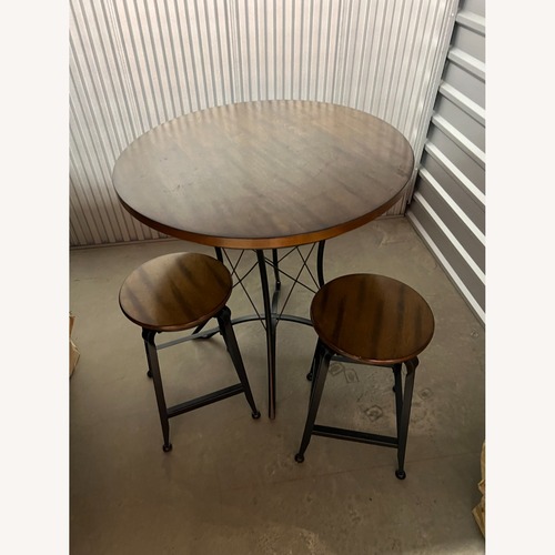 Used Steve Silver Co. Wooden Kitchen Table and Two Stools for sale on AptDeco