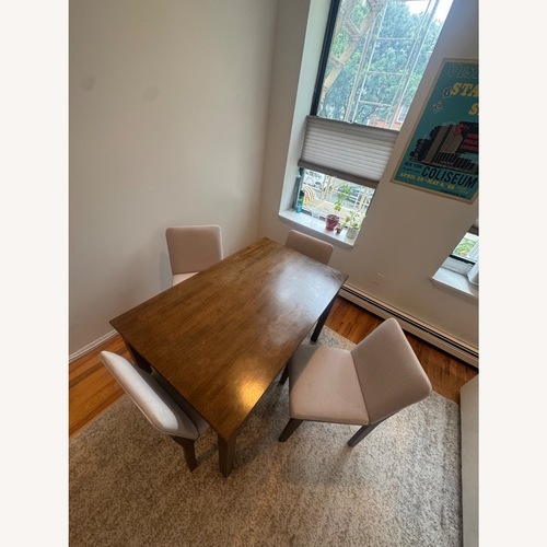 Used Wooden Table W Four Cushion Chairs for sale on AptDeco