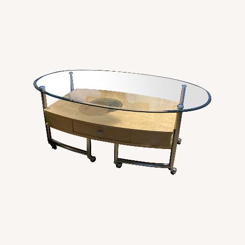 Used Glass Top Rolling Storage Base Coffee Table for sale on AptDeco