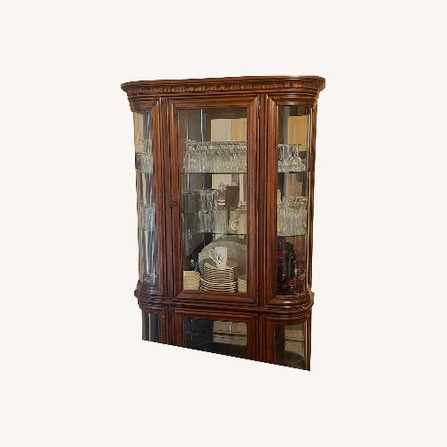 Used Ashley Cherry Oak 2-Tier China Cabinet for sale on AptDeco