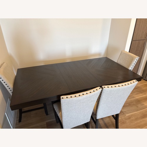 Used Dark Brown Wood Dining Table for sale on AptDeco