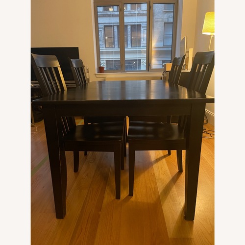 Used Elegant Black Wood Dining Set for sale on AptDeco