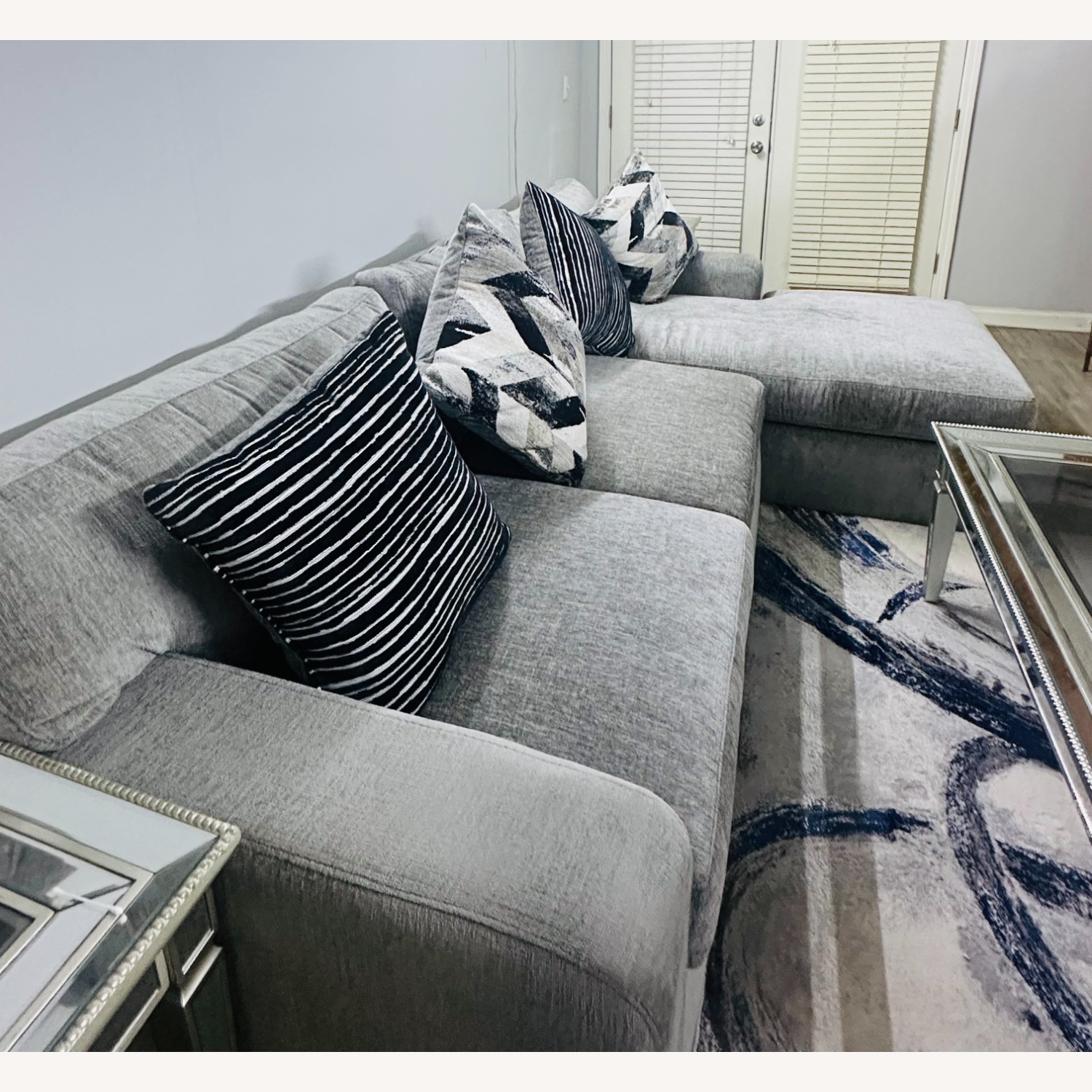 Rooms to go light Gray Fabric Sectional sofa set with chaise, 4 Accent Cushions, Mirrored Coffee & Side Tables, and Gray/Rug - image-3