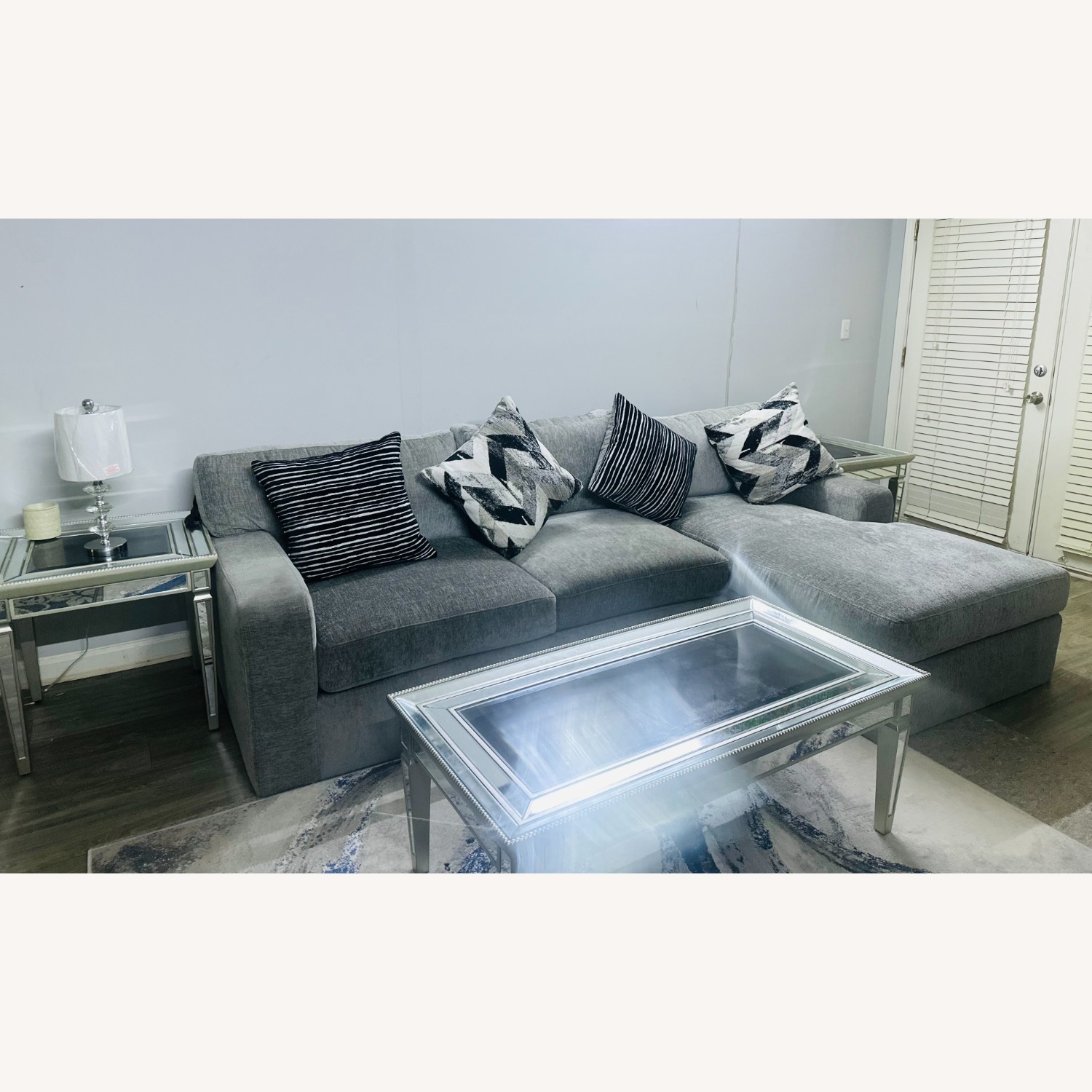 Rooms to go light Gray Fabric Sectional sofa set with chaise, 4 Accent Cushions, Mirrored Coffee & Side Tables, and Gray/Rug - image-1