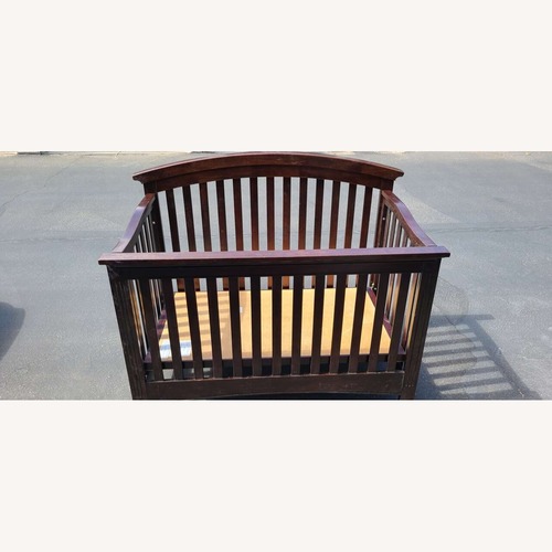 Used Quality Bliss Curved Top Wood Crib for sale on AptDeco