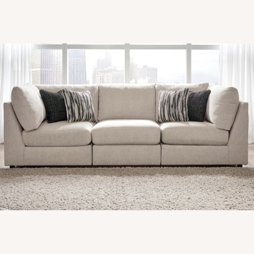 Used Ashley Furniture Kellway Beige Modular Couch & Ottoman for sale on AptDeco