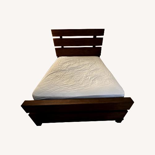 Used Raymour & Flanigan Dark Brown Wood Queen Bed for sale on AptDeco