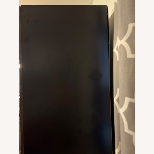 Used Raymour & Flanigan Dark Gray Wood Armoire for sale on AptDeco