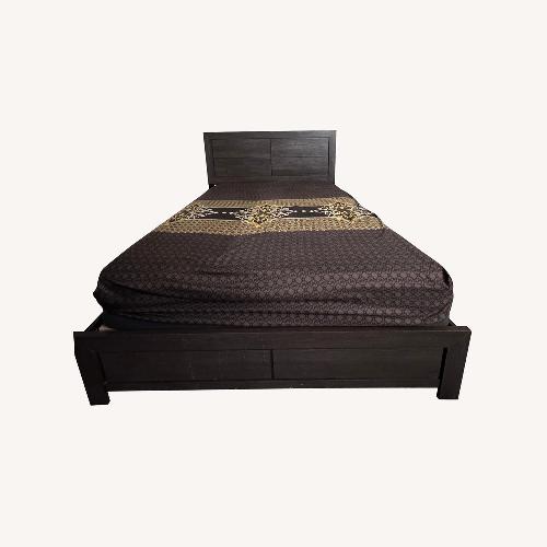 Used Raymour & Flanigan Dark Brown Wood Queen Bed for sale on AptDeco